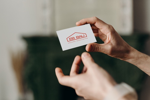 eduard boschmann business card hand holding a white business card with a red logo looking like a house