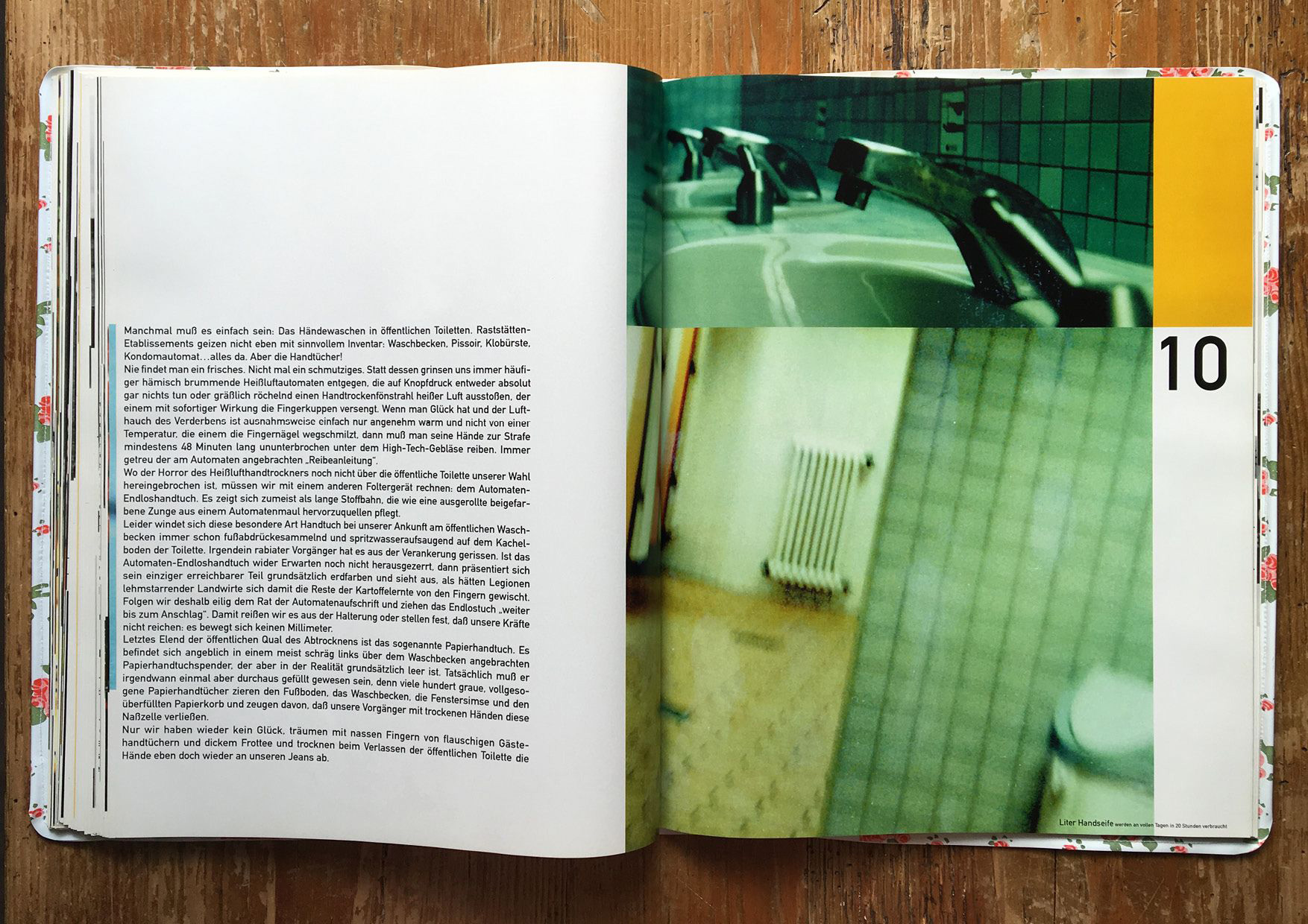 open raststatten book on wooden table with picture of rest stop restrooms 