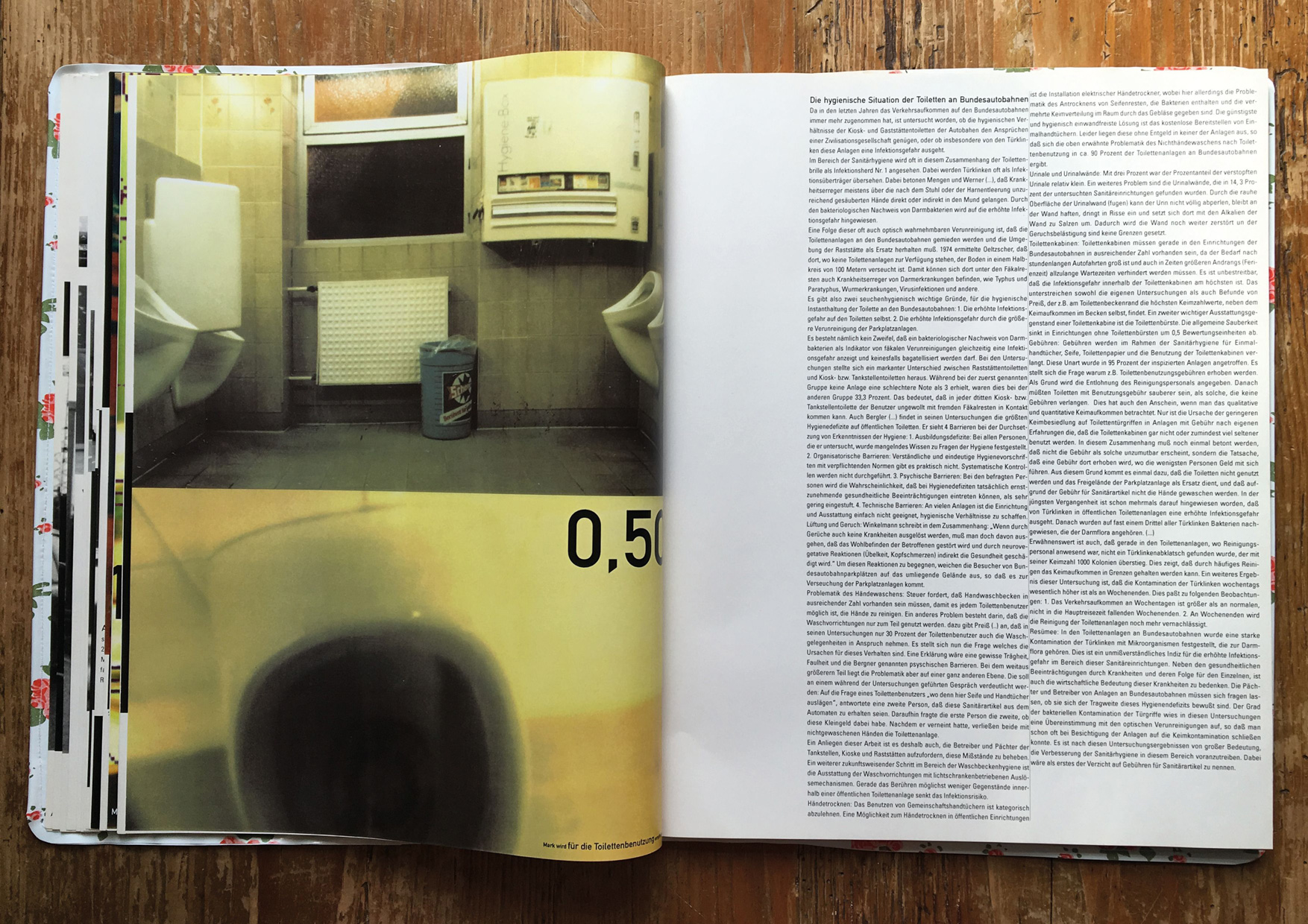 open raststatten book on wooden table with picture of rest stop restrooms 