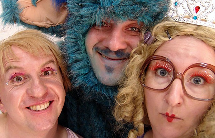 the he-fairy, the she-fairy and the monster team three grinning faces: a female fairy, a male fairy and a blue made up monster