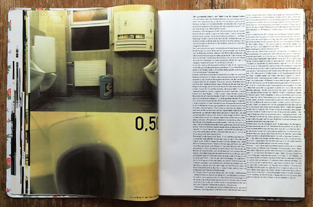 open raststatten book on wooden table with picture of rest stop restrooms 