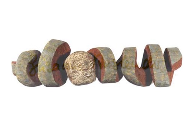 curled wooden sculpture with multi-faced head in the middle on a white background 